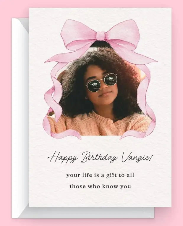 Happy Birthday Vangie card featuring a woman with curly hair and sunglasses, adorned with a pink bow.