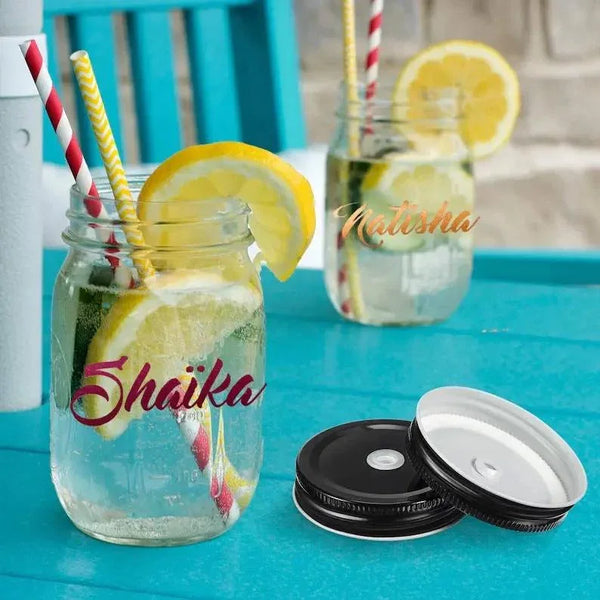 Personalized mason jars with names Shaika and Natisha, lemon slices, straws, on blue table