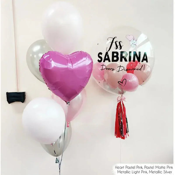 Personalized birthday balloon bouquet with pink heart, clear balloon saying 'Sabrina Doors Disarmed', in pastel and metallic shades